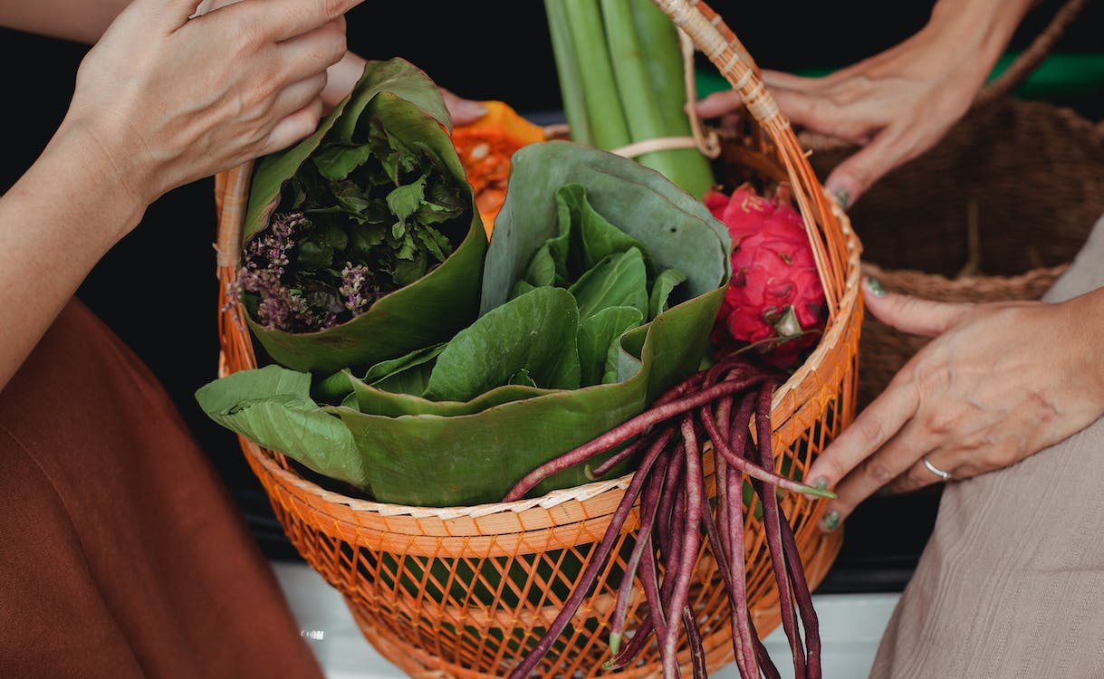 a close up of a basket filled with fruits and vegetables