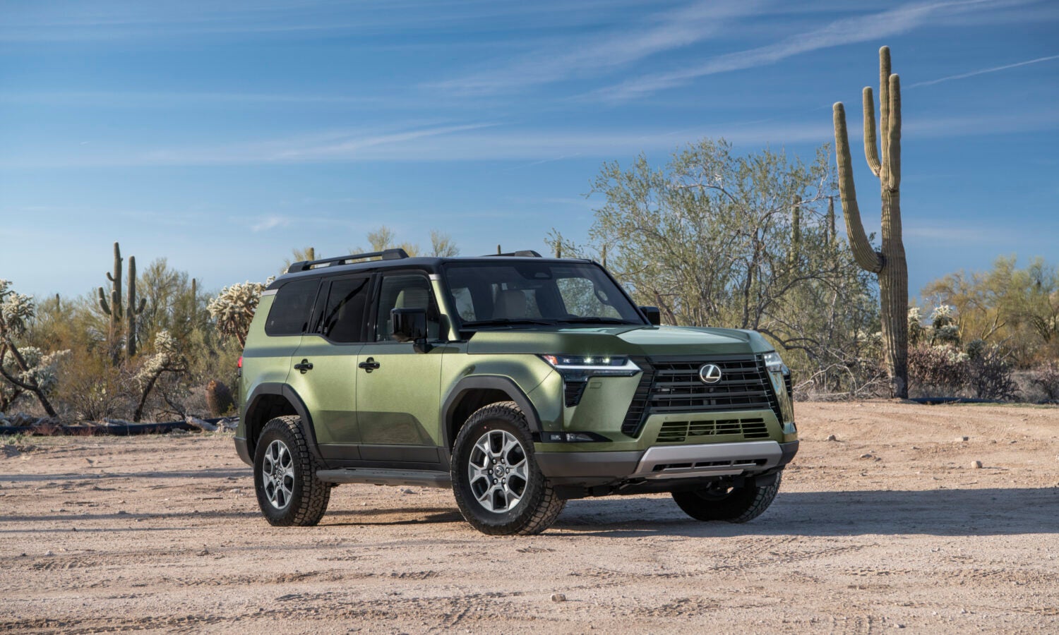 A green Lexus GX in the California desert